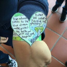 Picture of a child wearing a heart bracelet he made