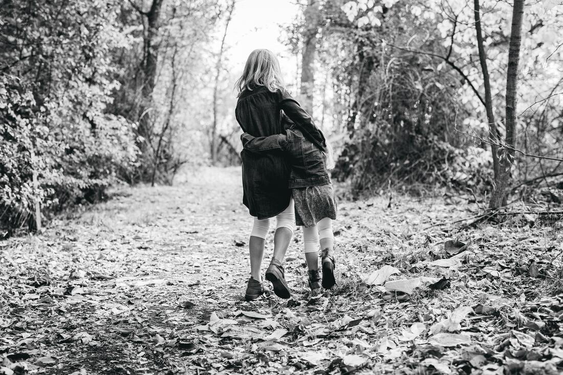 Picture of two children walking in the woods