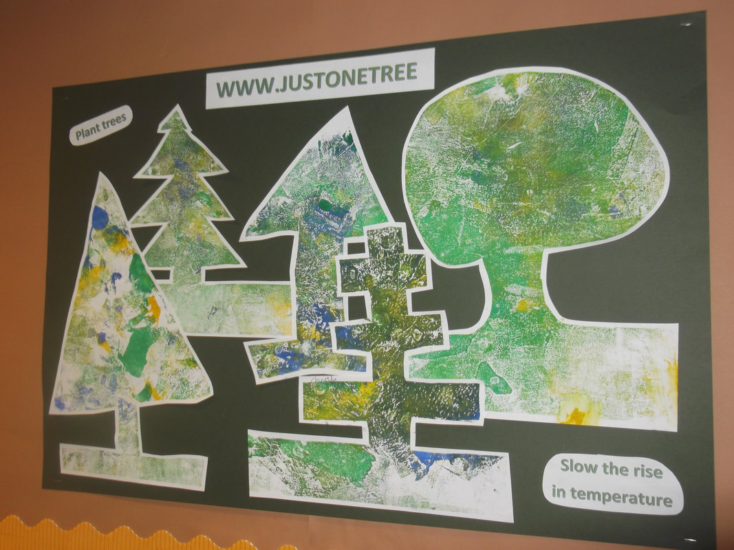 A poster of a forest made by school children, promoting JUST ONE Tree