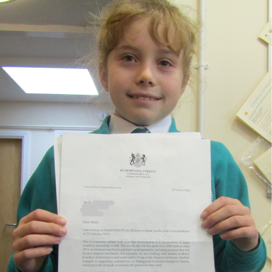 Picture of Molly holding her letter from the government about deforestation