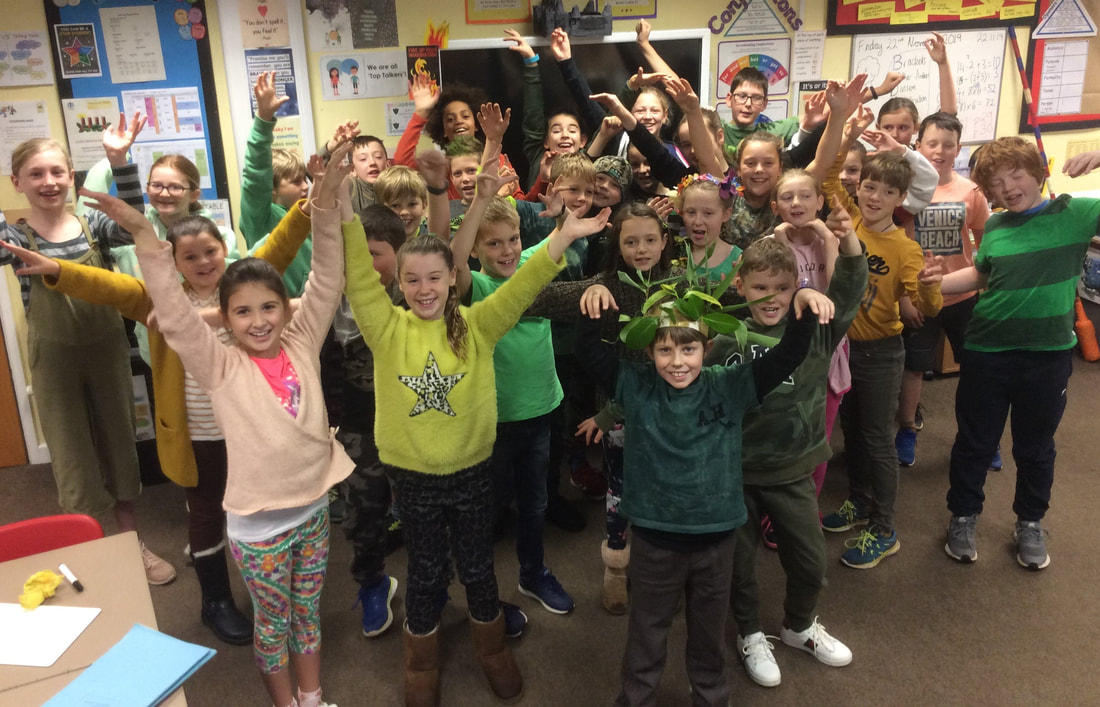 Picture of children dressed up in green for their JUST ONE Tree Day