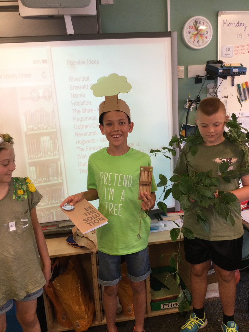 Picture of children dressed as trees giving a presentation at school
