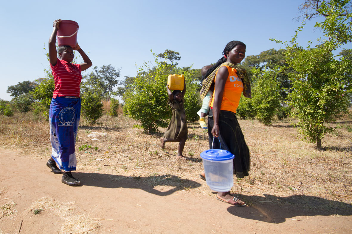 Zambian women carrying water