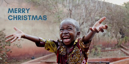 Picture of African boy smiling in the rain